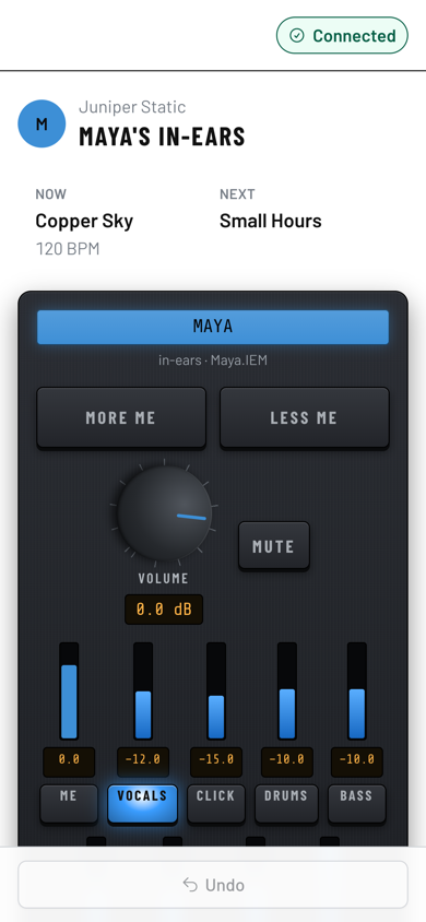 A phone showing Maya's in-ears with the current and next song, More me and Less me, a volume knob and sliders for vocals, click, drums and bass. (Daylight version)